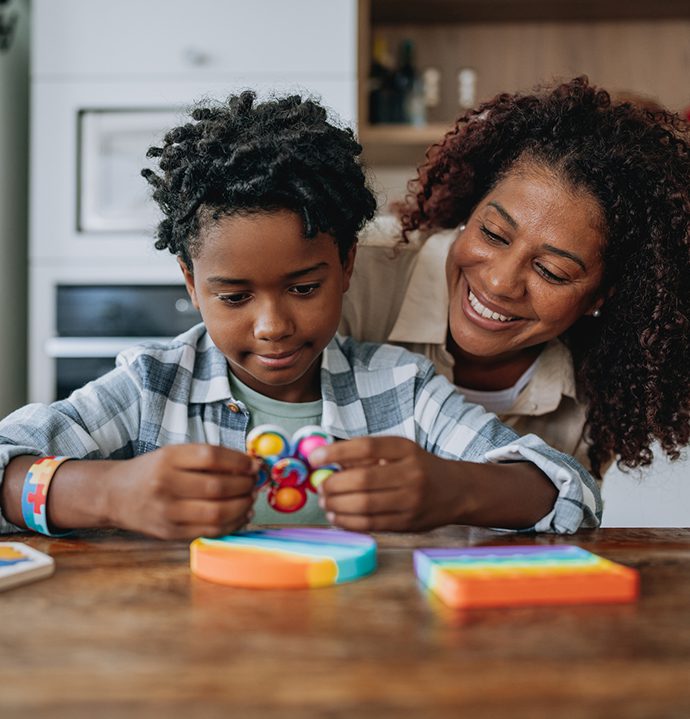 Mother playing with autistic son Autism Spectrum Program